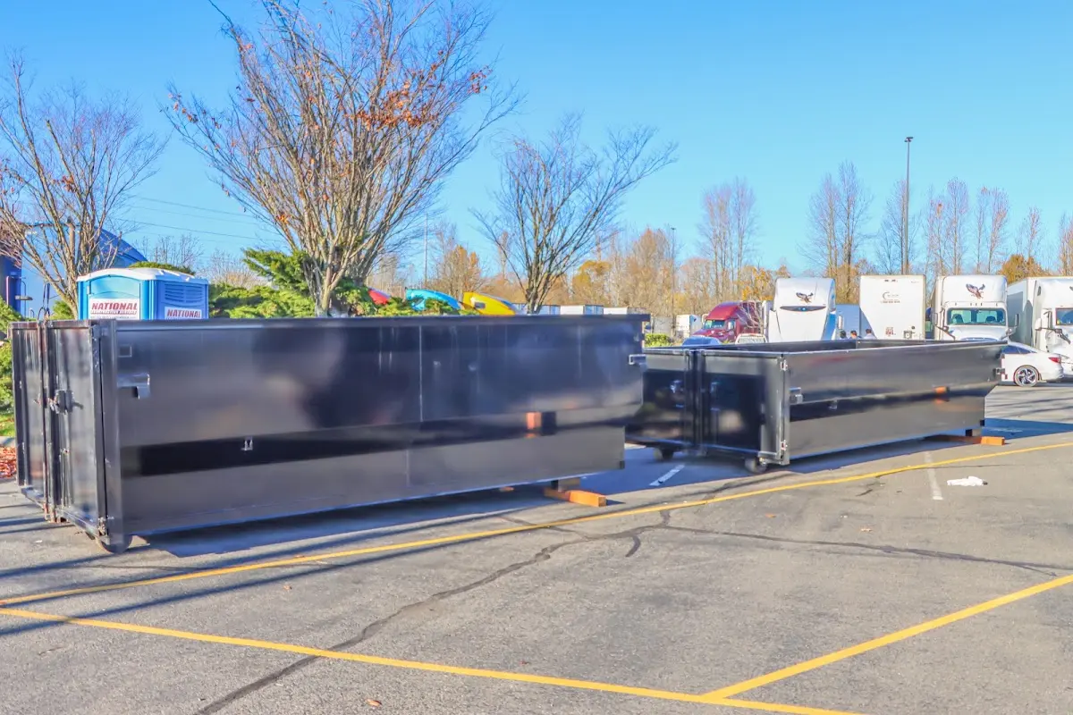 Professional dumpster rental service with roll-off container on residential driveway in Schiller Park